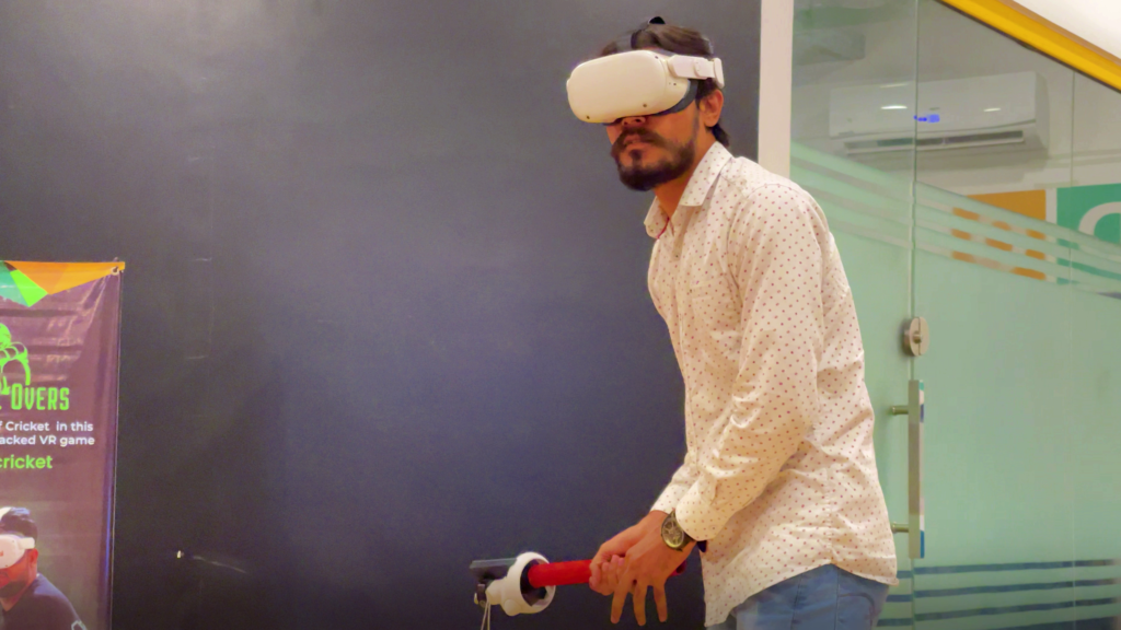 A youth is playing VR cricket with a bat